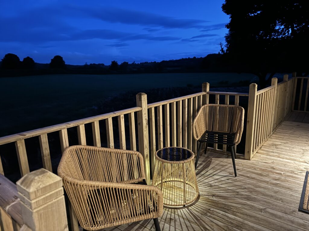 Decking at night in Unbox Poplar Holiday Lodge